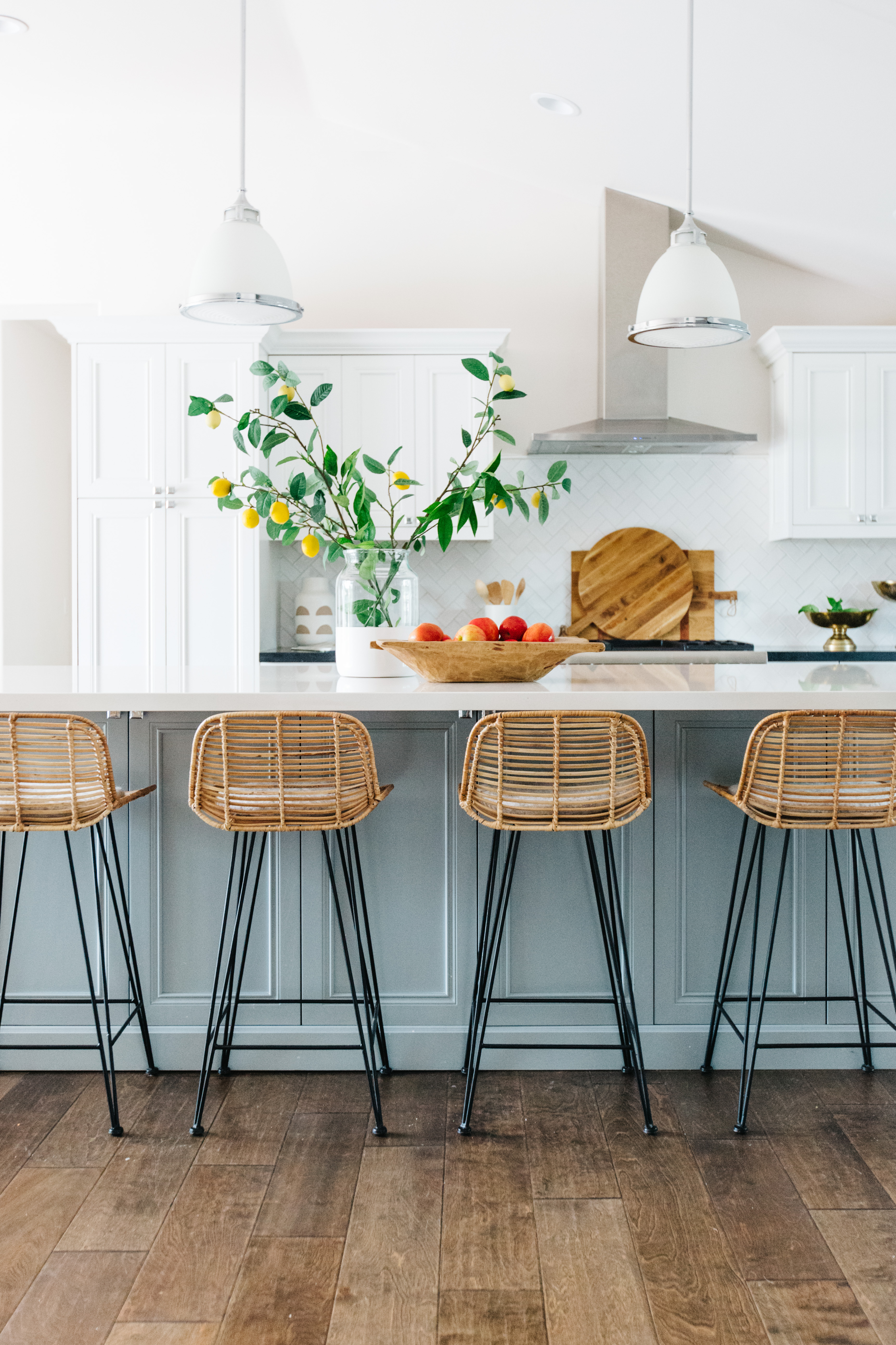 wicker barstools with a glue gray painted cabinets and white counter